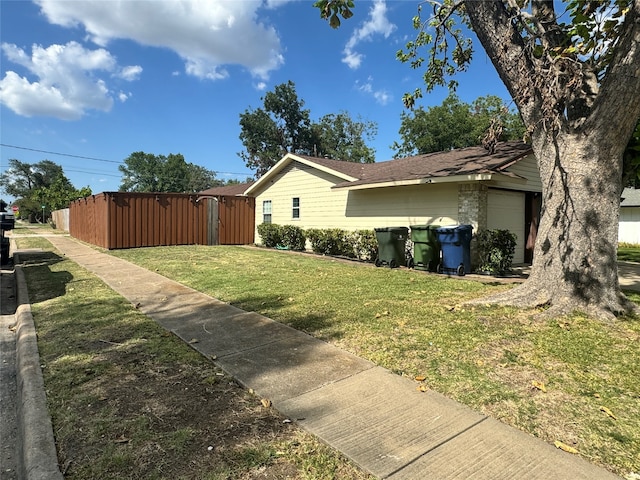 view of side of property with a yard