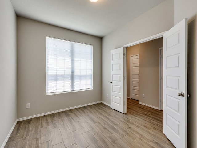 unfurnished bedroom featuring light wood-type flooring