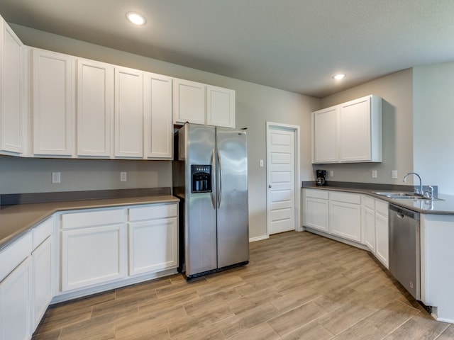 kitchen with white cabinetry, appliances with stainless steel finishes, and sink