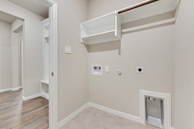 laundry area with hookup for a washing machine, hookup for a gas dryer, light hardwood / wood-style floors, and hookup for an electric dryer