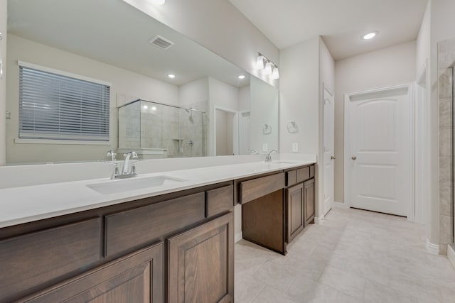 bathroom with tile patterned flooring, vanity, and an enclosed shower