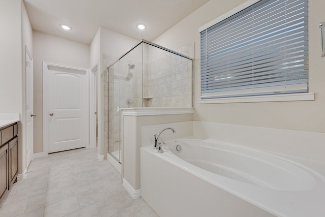 bathroom featuring shower with separate bathtub, tile patterned flooring, and vanity