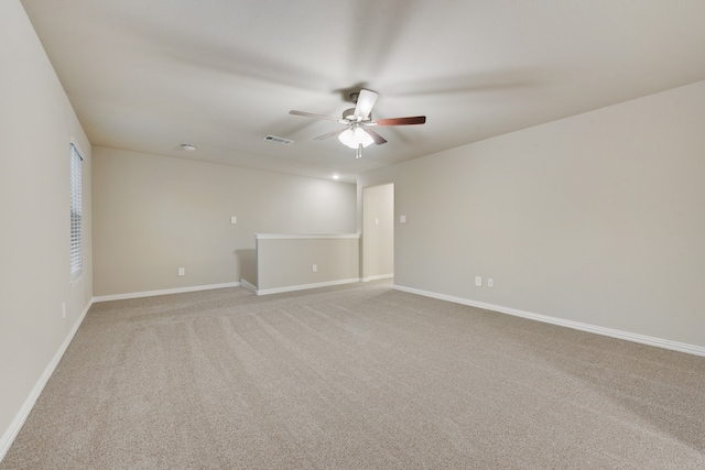 carpeted spare room with ceiling fan