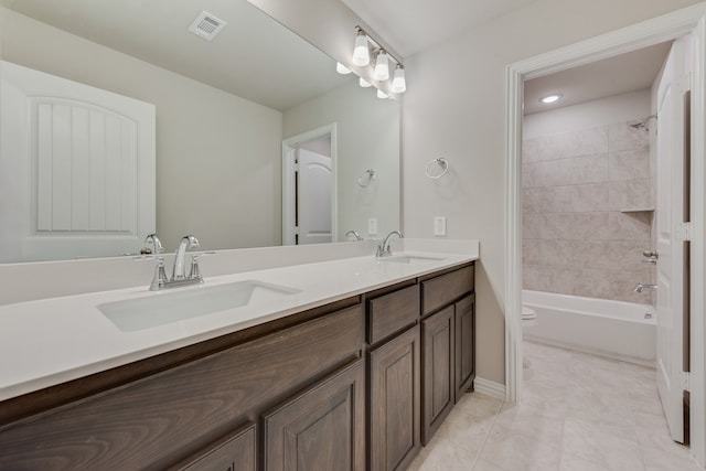 full bathroom featuring vanity, toilet, and tiled shower / bath