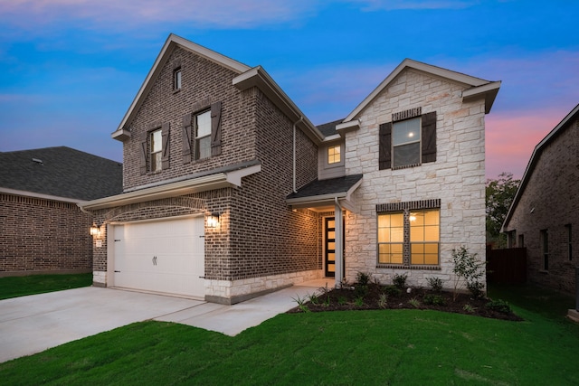 view of front of house featuring a garage and a lawn