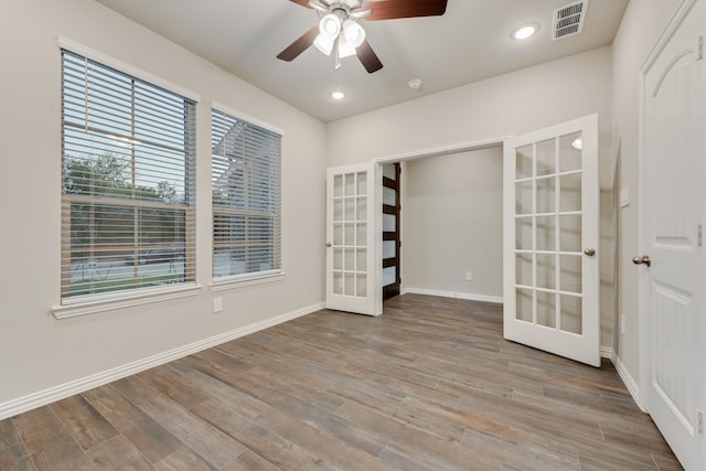 spare room with french doors, light hardwood / wood-style flooring, and ceiling fan