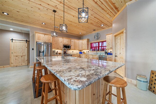 kitchen featuring finished concrete flooring, stainless steel appliances, light brown cabinetry, a barn door, and wooden ceiling