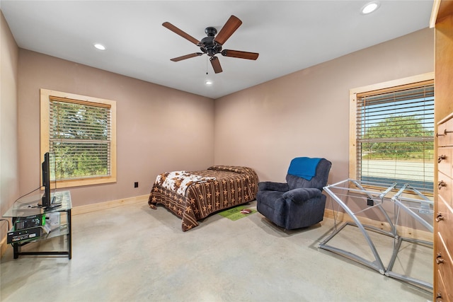 bedroom with recessed lighting, multiple windows, and concrete flooring