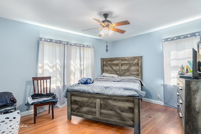 bedroom with ceiling fan and wood-type flooring