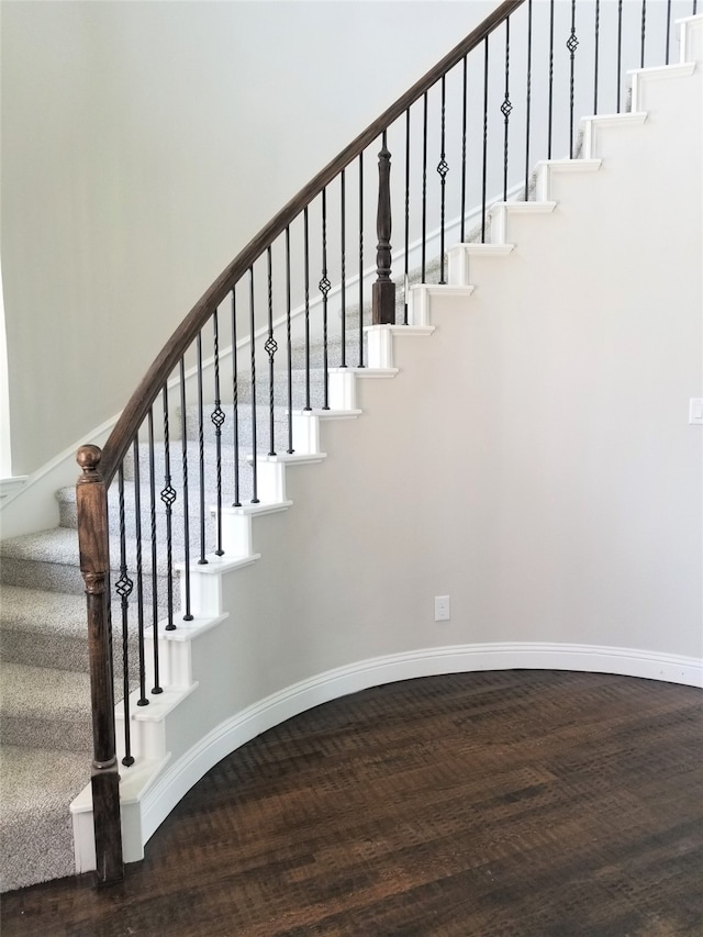 stairs featuring hardwood / wood-style floors