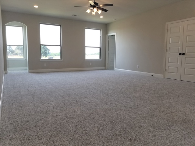 unfurnished room featuring light carpet and ceiling fan