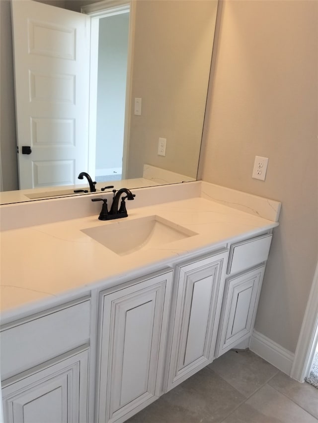 bathroom with tile patterned floors and vanity