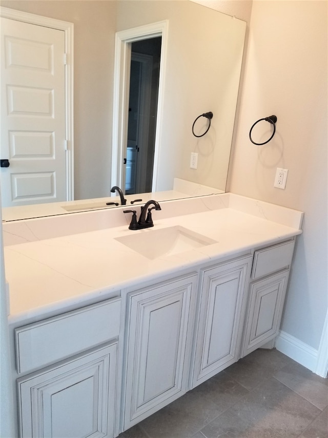 bathroom featuring tile patterned flooring and vanity