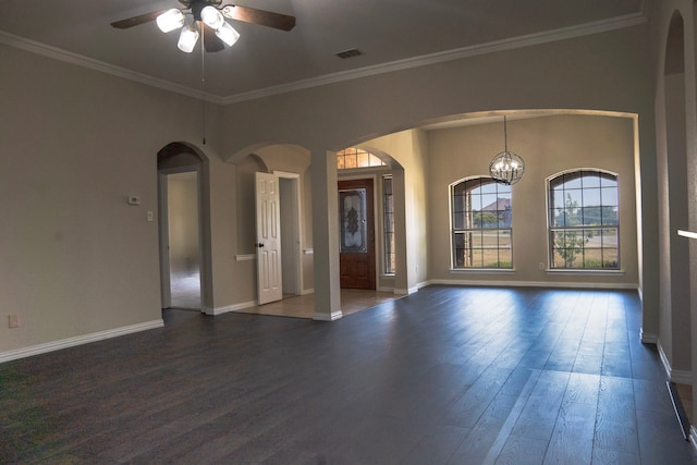 spare room with ceiling fan with notable chandelier, crown molding, and dark wood-type flooring