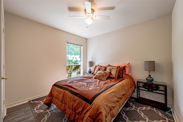 bedroom with ceiling fan and dark hardwood / wood-style floors