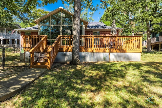 back of house featuring a wooden deck and a lawn