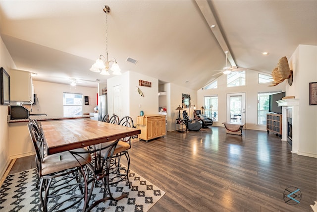 dining space featuring a fireplace, plenty of natural light, ceiling fan with notable chandelier, and dark hardwood / wood-style floors