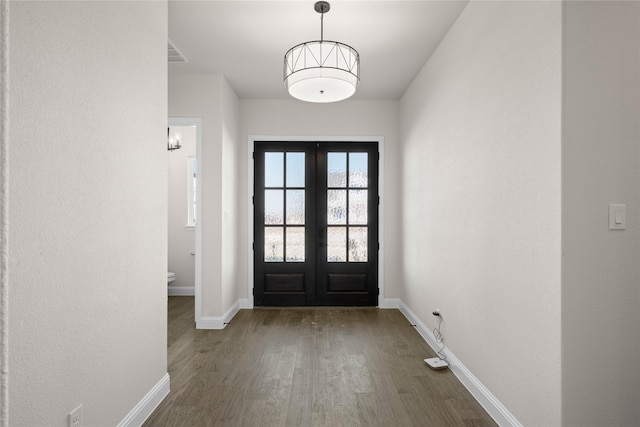 entryway with dark wood-type flooring and french doors