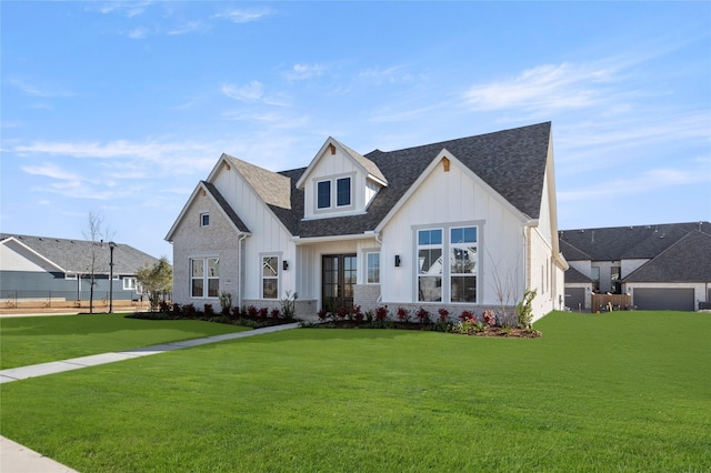 modern inspired farmhouse with a front lawn