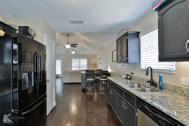 kitchen featuring dishwasher, sink, ceiling fan, dark wood-type flooring, and black fridge