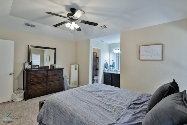 carpeted bedroom with connected bathroom and ceiling fan