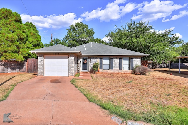 ranch-style home featuring a front yard and a garage