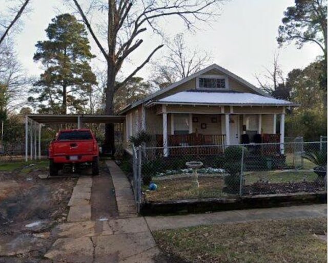 bungalow-style home featuring a carport and covered porch