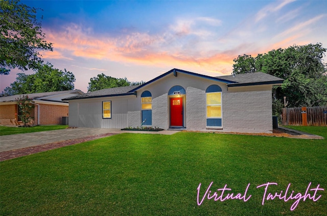 ranch-style home with a lawn