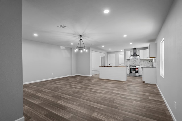 unfurnished living room featuring wood-type flooring and sink