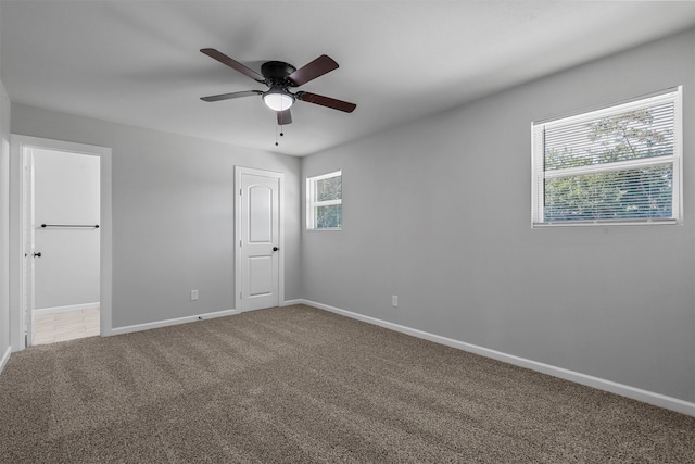 unfurnished room with carpet and ceiling fan