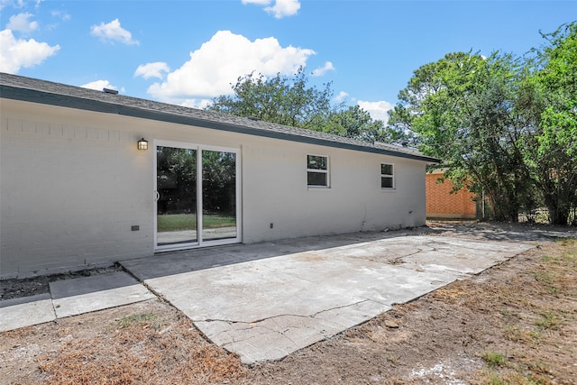 back of property with a patio