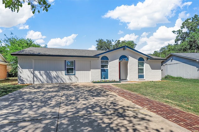 ranch-style home with a front lawn