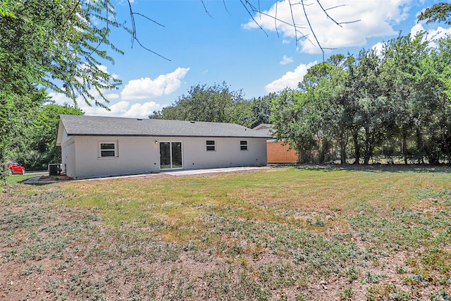 rear view of property featuring a yard