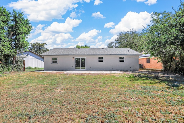 rear view of property featuring a patio, central air condition unit, and a lawn