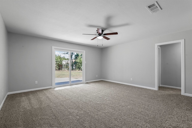 carpeted spare room with ceiling fan and a textured ceiling