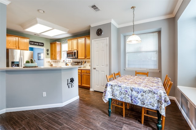 dining area featuring ornamental molding and dark wood-type flooring