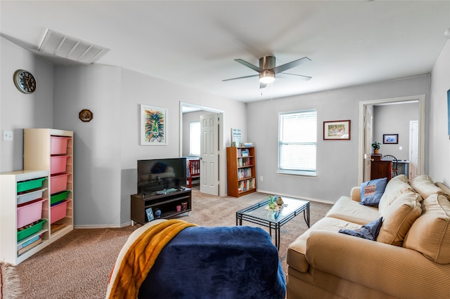 carpeted living room with ceiling fan