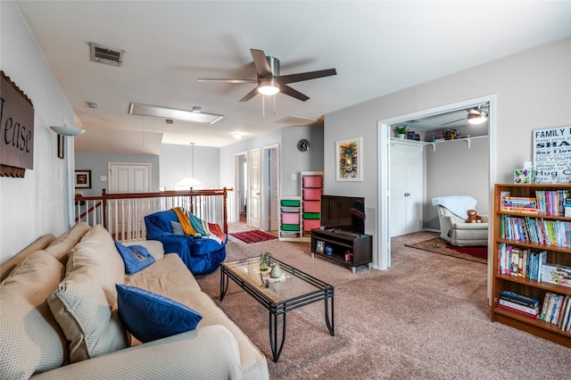 carpeted living room featuring ceiling fan