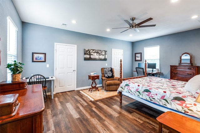 bedroom with dark hardwood / wood-style floors and ceiling fan