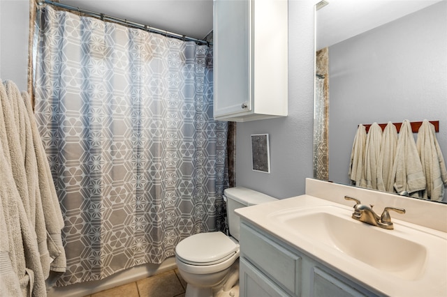 bathroom with walk in shower, tile patterned flooring, vanity, and toilet