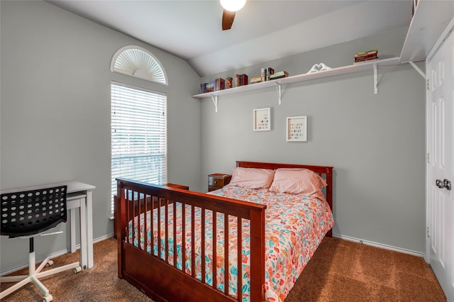 bedroom featuring dark colored carpet, vaulted ceiling, and ceiling fan