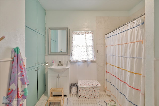 bathroom featuring a shower with shower curtain, tile patterned flooring, and vanity