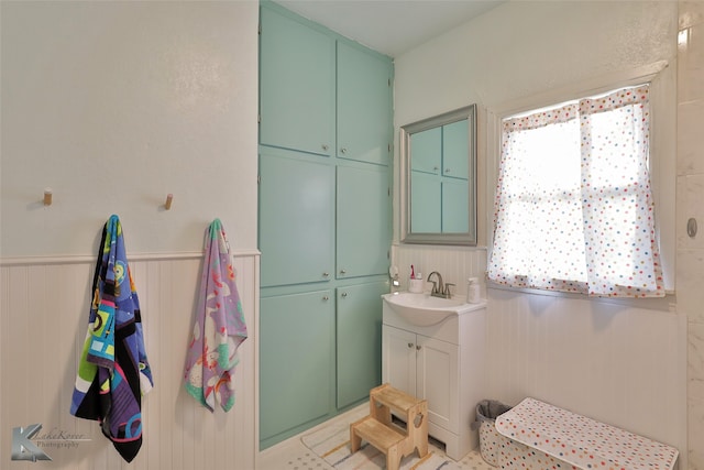 bathroom featuring vanity, a shower, and tile patterned floors