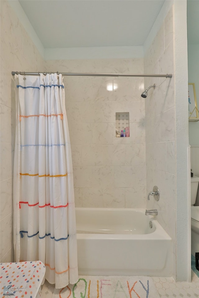 bathroom featuring toilet, shower / bath combination with curtain, and tile patterned floors