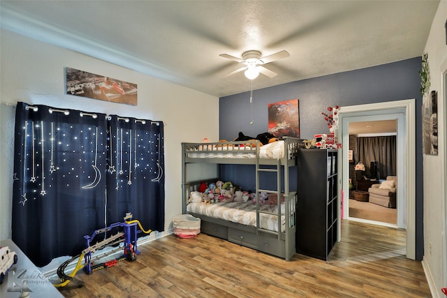 bedroom with wood-type flooring and ceiling fan