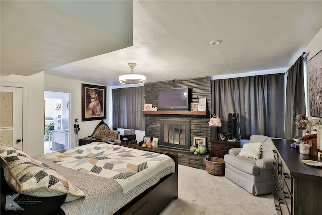 bedroom with light colored carpet, connected bathroom, and a brick fireplace