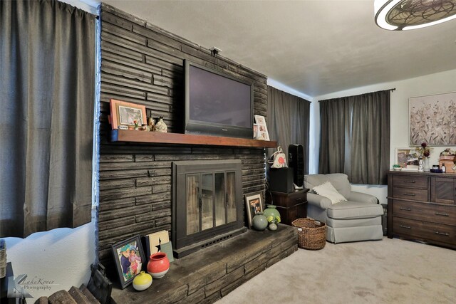 living room with carpet flooring and a fireplace