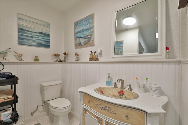 bathroom featuring vanity, toilet, and tile patterned flooring