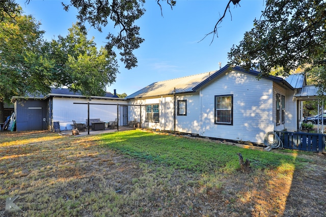 back of property featuring a lawn