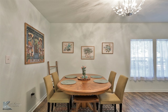 dining area with dark hardwood / wood-style flooring, a notable chandelier, and a healthy amount of sunlight